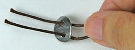 button threaded onto cord